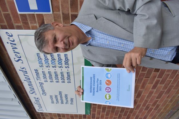 An image of Cllr Crump holding up the new business plan