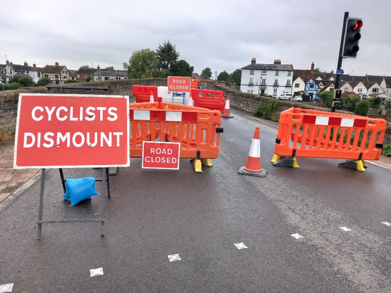 Road bridge blocked off with road signs and cones