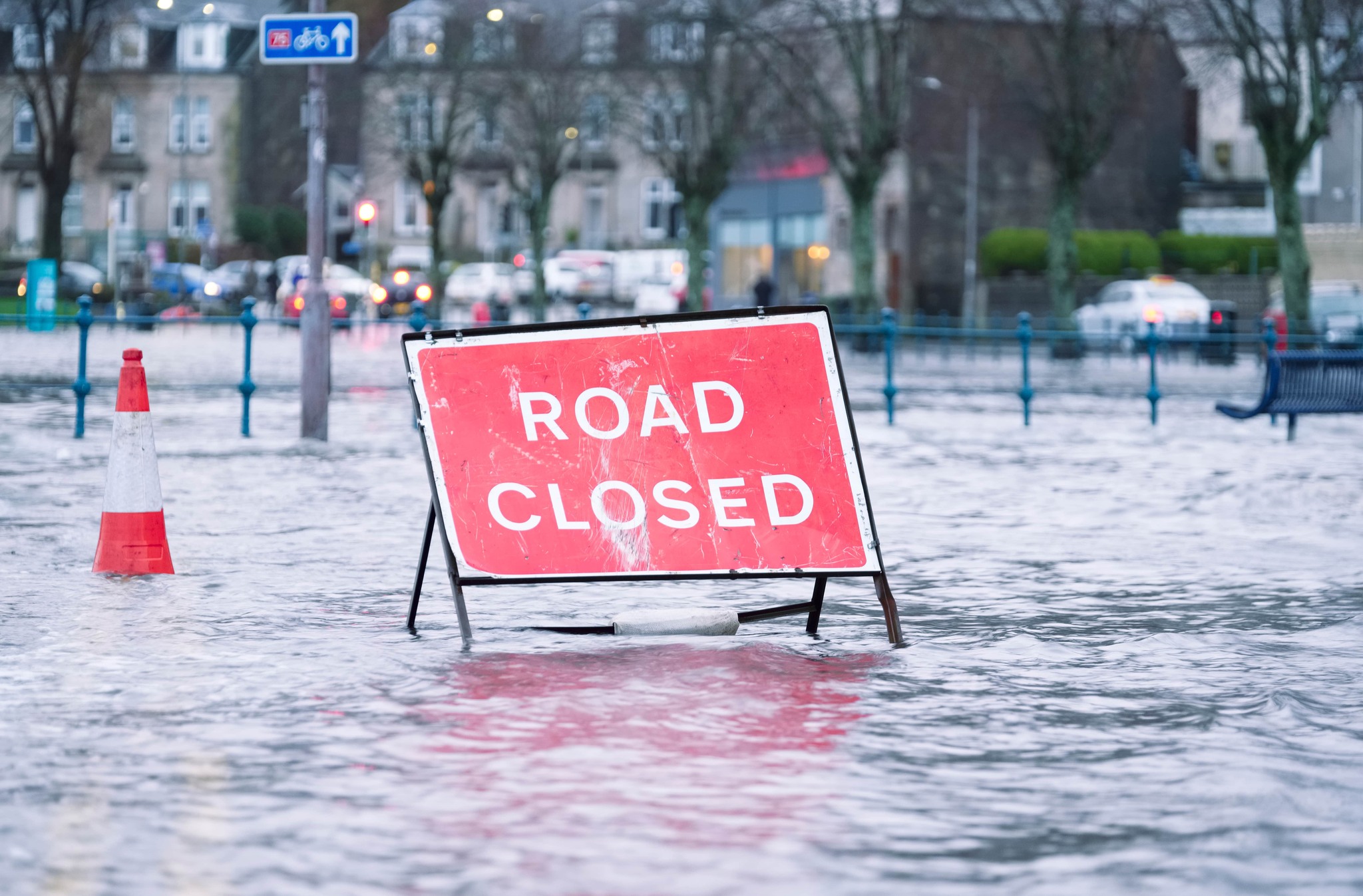 'Road closed' sign on a flooded street.
