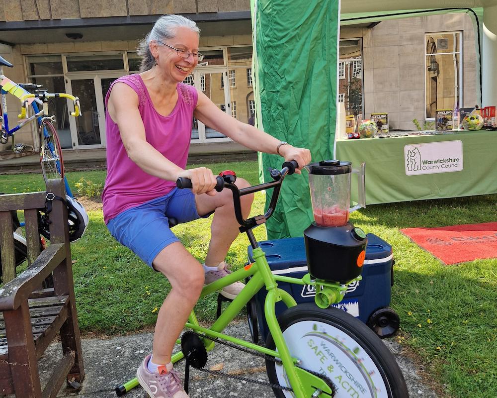 A picture of the smoothie bike in action at a community event