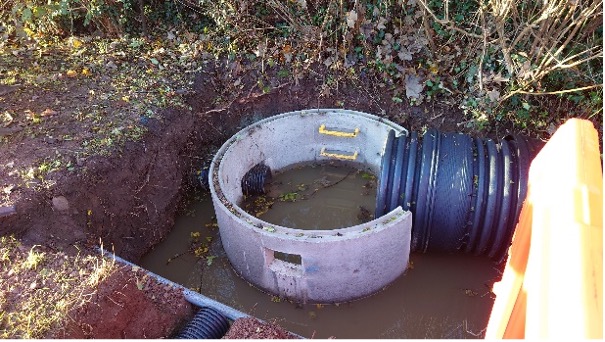 Downstream manhole and pipe connections in western outbound verge by Worths Way