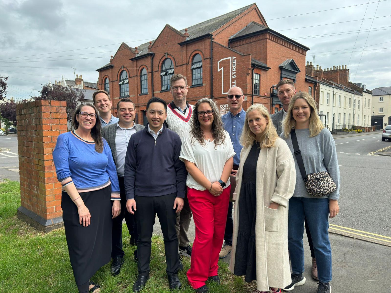 A group of people standing in front of a building