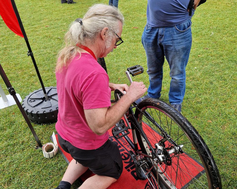 An image of someone applying security markings to a bike at a local event