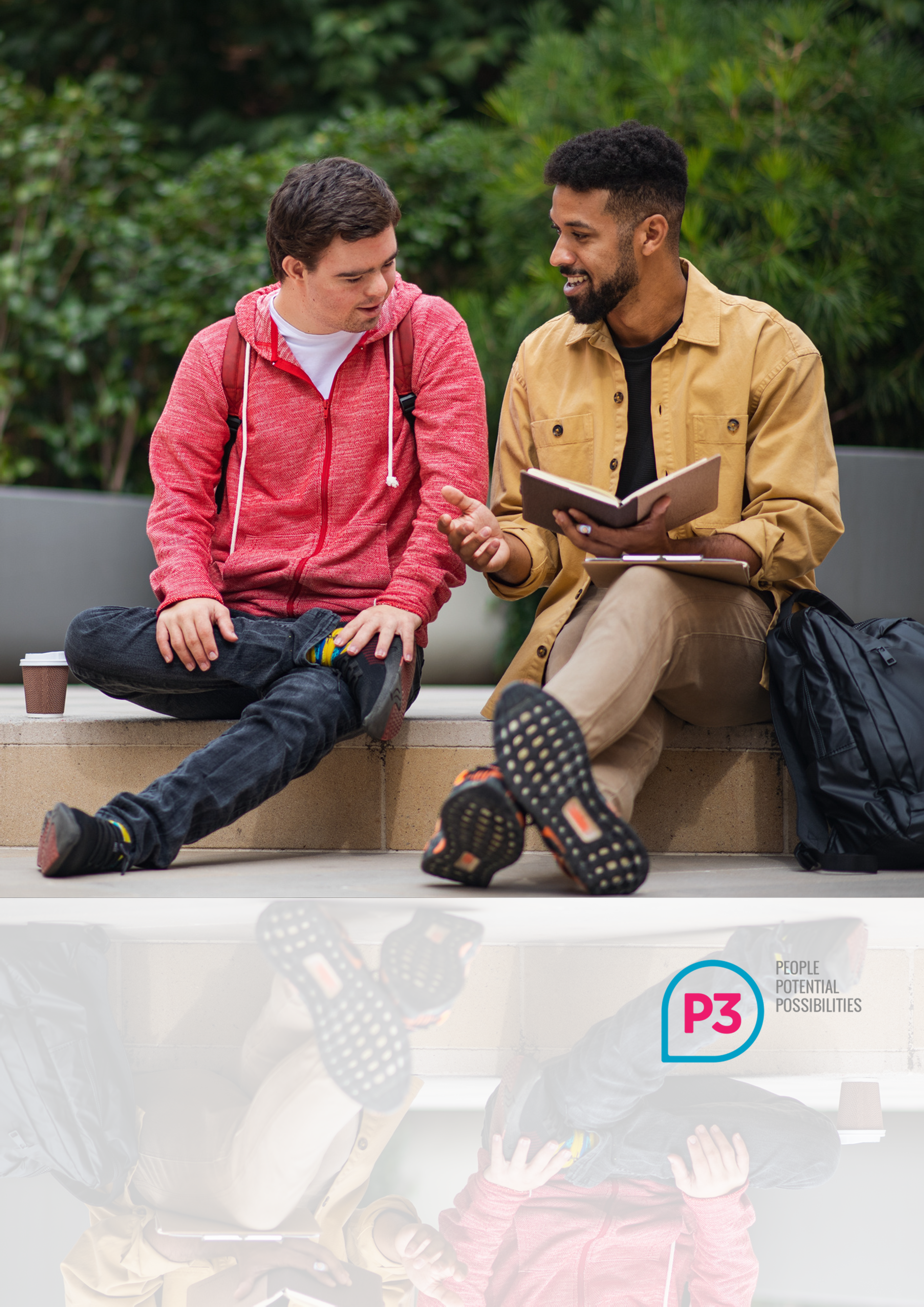 Image of two men with a book talking and smiling