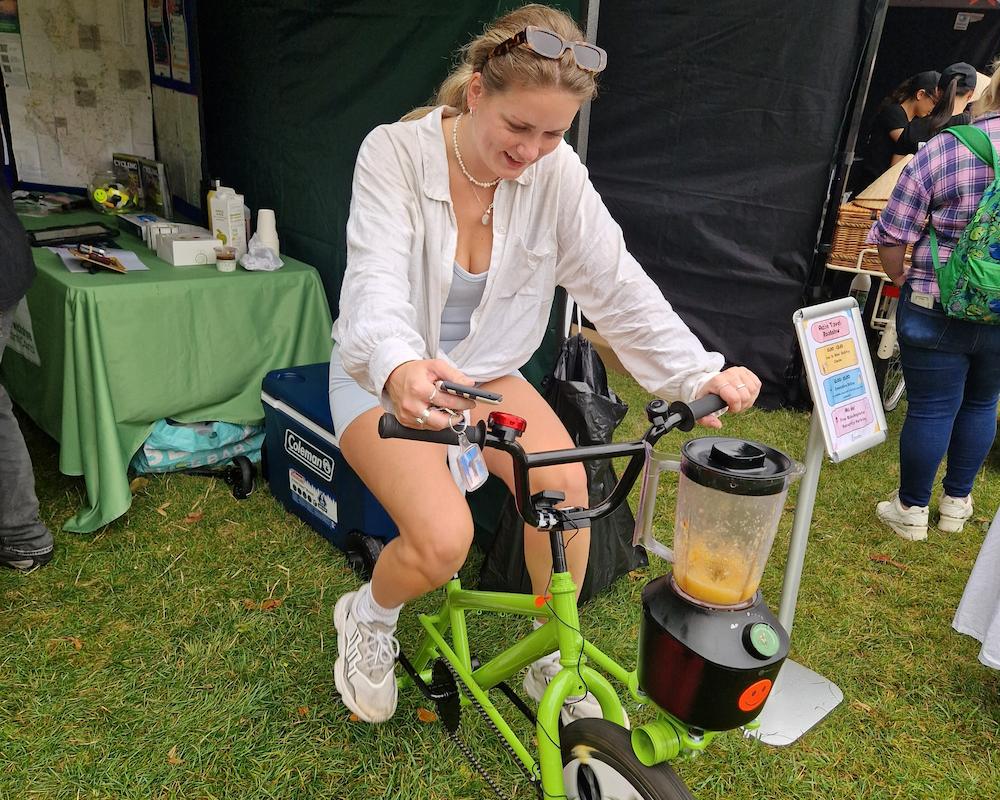 A picture of the smoothie bike in use at a food festival