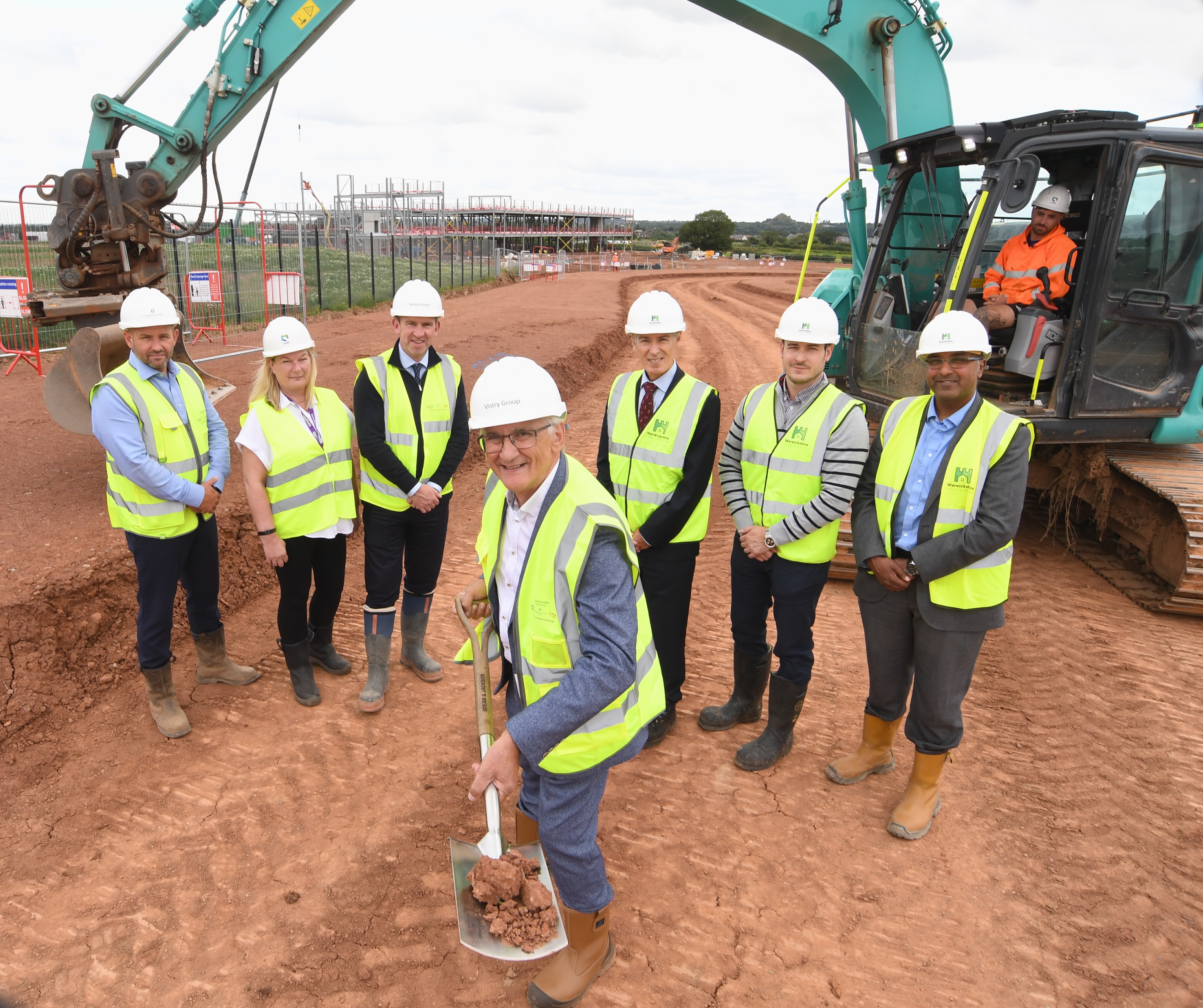 From left to right, Leighton Claire (Vistry), Joanne Noakes (Platform Housing Group), Phil McHugh (Vistry), Cllr Peter Butlin, James Devereux (WPDG), Rob Andrews (WPDG) and Stuart Buckley (WPDG) at the Top Farm construction site in Weddington.
