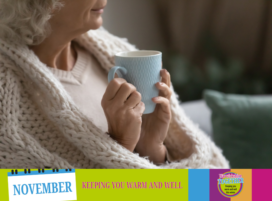 Woman wrapped in blanket holding a mug