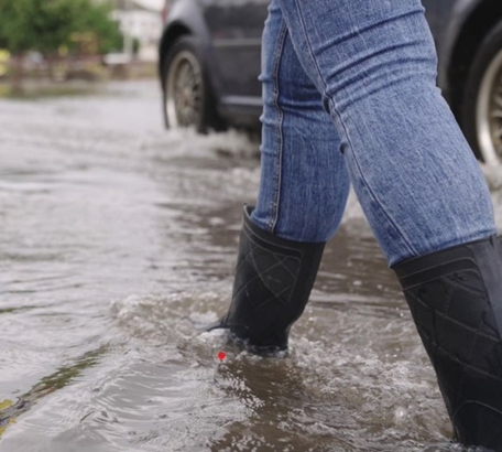 Person walking through surface water in wellies