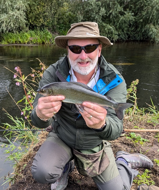 A person holding a fish