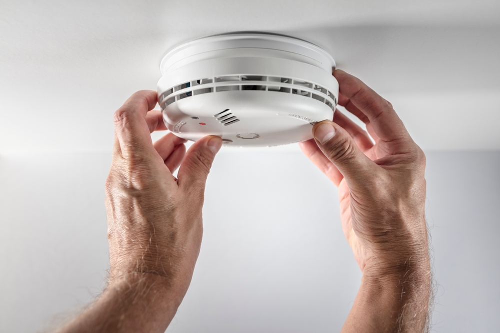 Photo of someone fitting a smoke alarm