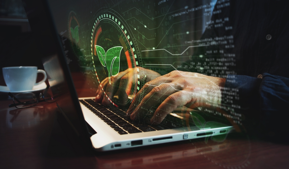 Hands typing on keyboard with leaf overlay