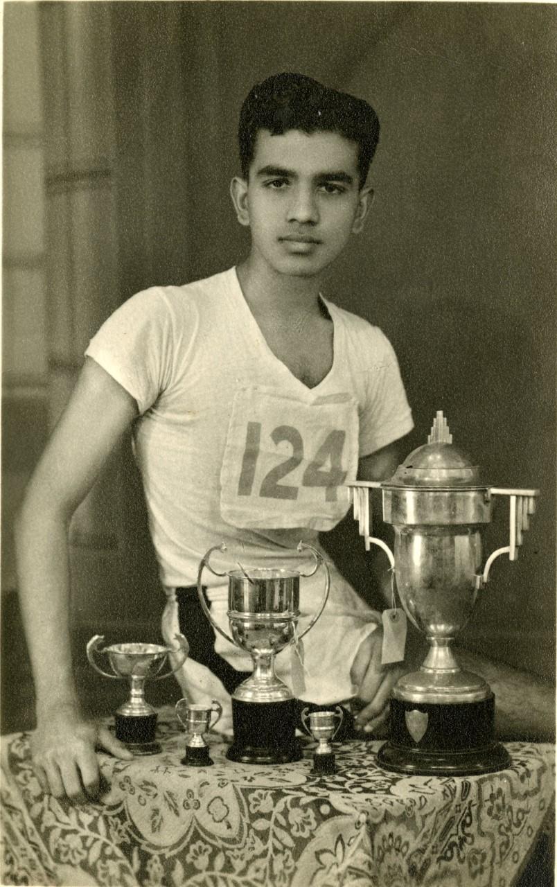 Photograph of Horace Boyer with several trophies
